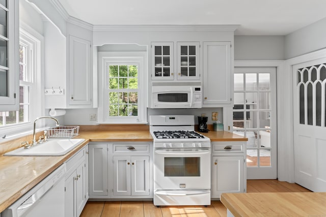 1 Dover Cir, Newtown, CT 06470 - kitchen with white appliances, a sink, glass insert cabinets, white cabinets, and light wood-style flooring