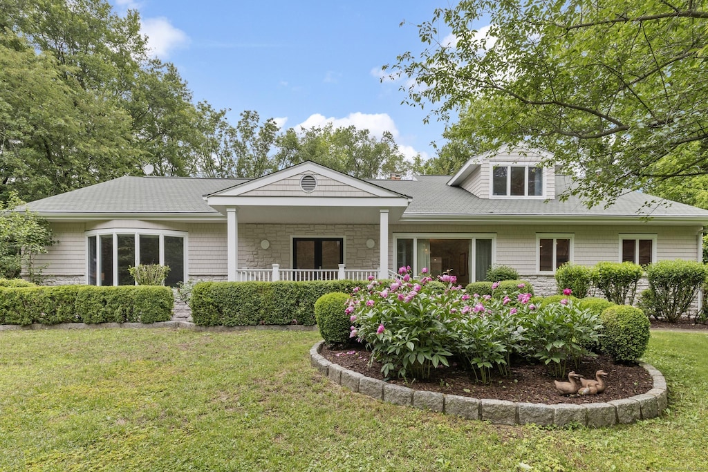 124 Westover Ln, Stamford, CT 06902 - view of front of house featuring a front yard, stone siding, and a porch