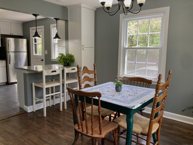 59 Overlook Dr, Manchester, CT 06042 - dining area with dark wood-style floors, a chandelier, and baseboards