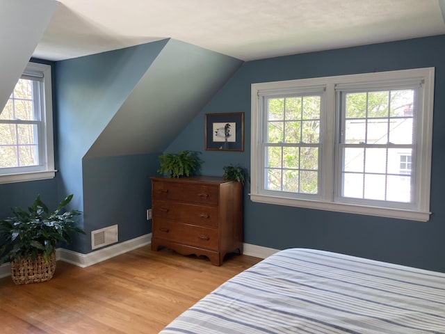 59 Overlook Dr, Manchester, CT 06042 - bedroom with multiple windows, light wood finished floors, vaulted ceiling, and baseboards