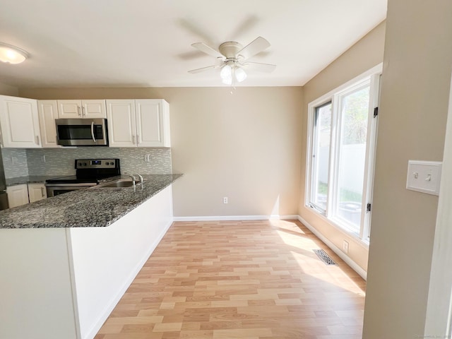 279 New Haven Ave Apt H, Milford, CT 06460 - kitchen with stainless steel appliances, plenty of natural light, backsplash, and a sink