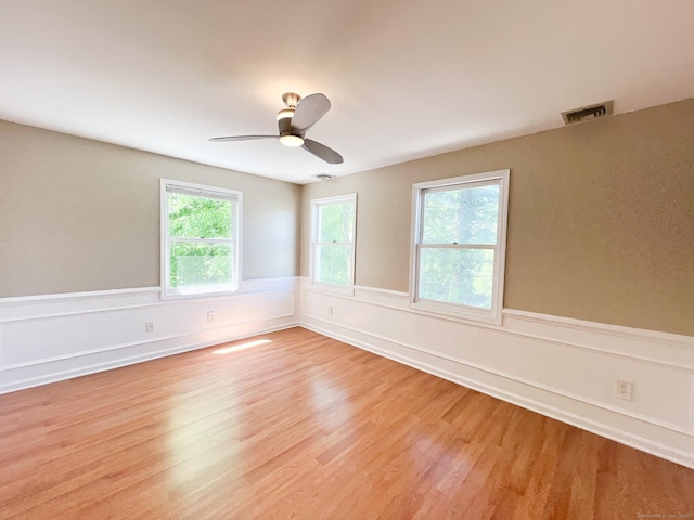 279 New Haven Ave Apt H, Milford, CT 06460 - spare room with light wood finished floors, wainscoting, and a ceiling fan