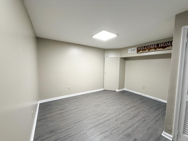 279 New Haven Ave Apt H, Milford, CT 06460 - finished below grade area with dark wood-style flooring and baseboards