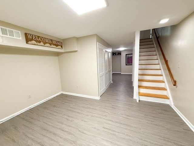 279 New Haven Ave Apt H, Milford, CT 06460 - finished below grade area with wood finished floors, baseboards, and stairs