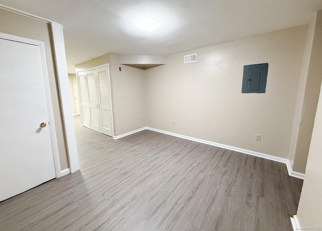 279 New Haven Ave Apt H, Milford, CT 06460 - spare room featuring electric panel, wood finished floors, and baseboards