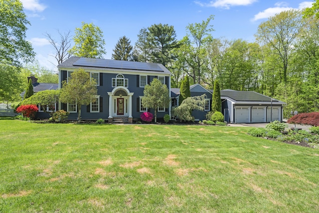 9 Benham Hill Pl, Hamden, CT 06514 - colonial house featuring solar panels, a front lawn, an outbuilding, a garage, and driveway