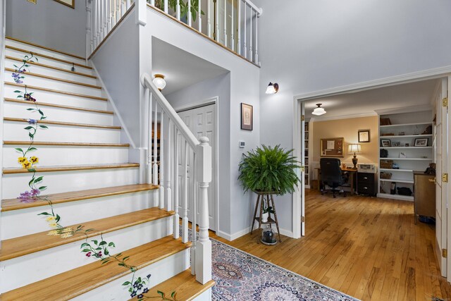 9 Benham Hill Pl, Hamden, CT 06514 - stairs featuring hardwood / wood-style floors, a high ceiling, and baseboards