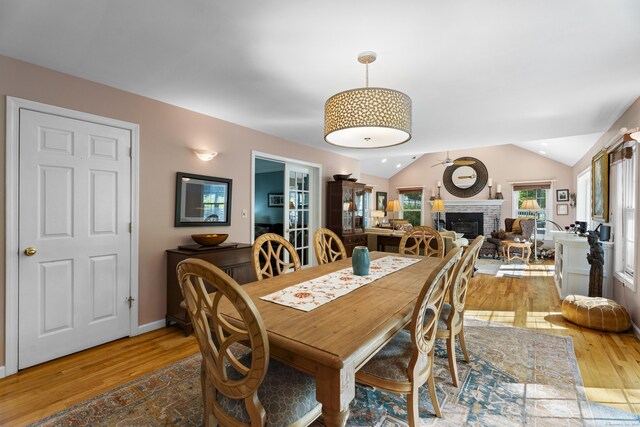 9 Benham Hill Pl, Hamden, CT 06514 - dining area featuring a brick fireplace, light wood-style flooring, and vaulted ceiling
