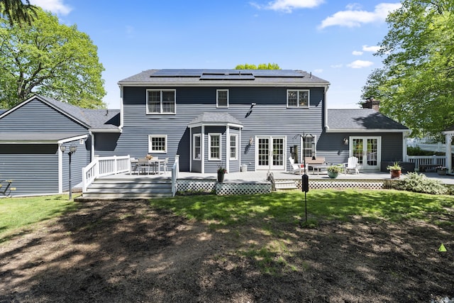 9 Benham Hill Pl, Hamden, CT 06514 - back of property with a yard, a deck, a chimney, and solar panels