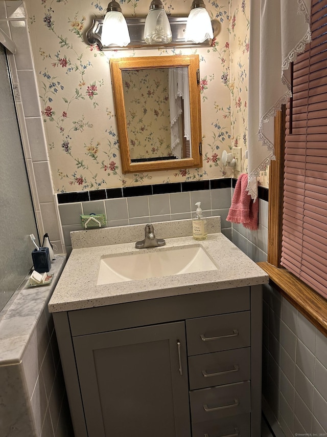 119 Chambers St, Manchester, CT 06042 - bathroom featuring wallpapered walls, vanity, tile walls, and a wainscoted wall