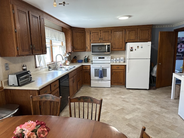 119 Chambers St, Manchester, CT 06042 - kitchen with white appliances, a sink, light countertops, and brown cabinetry