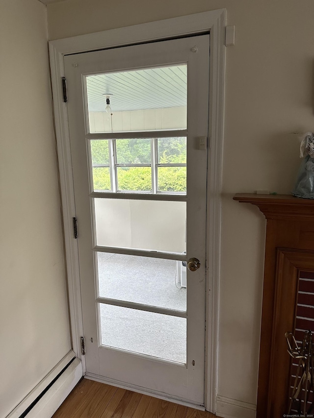119 Chambers St, Manchester, CT 06042 - doorway to outside featuring baseboard heating and wood finished floors