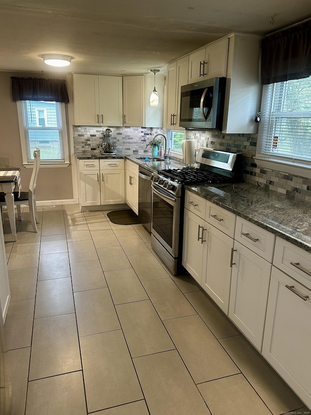 140 Clintonville Rd, North Haven, CT 06473 - kitchen featuring appliances with stainless steel finishes, decorative backsplash, a sink, and white cabinets