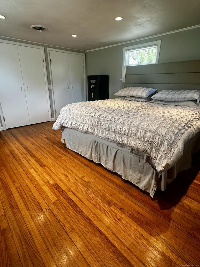 140 Clintonville Rd, North Haven, CT 06473 - bedroom featuring crown molding, wood finished floors, recessed lighting, and multiple closets