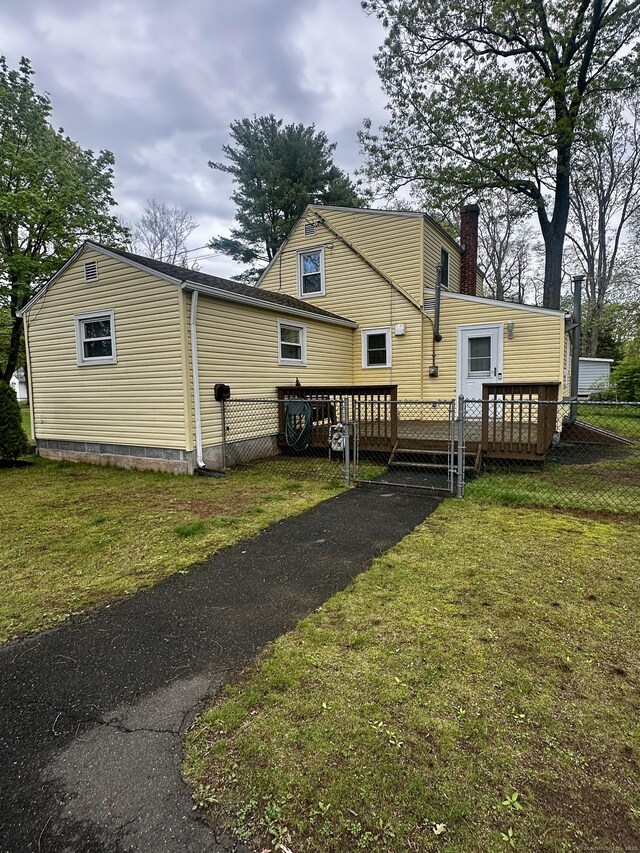140 Clintonville Rd, North Haven, CT 06473 - rear view of house with a wooden deck and a chimney