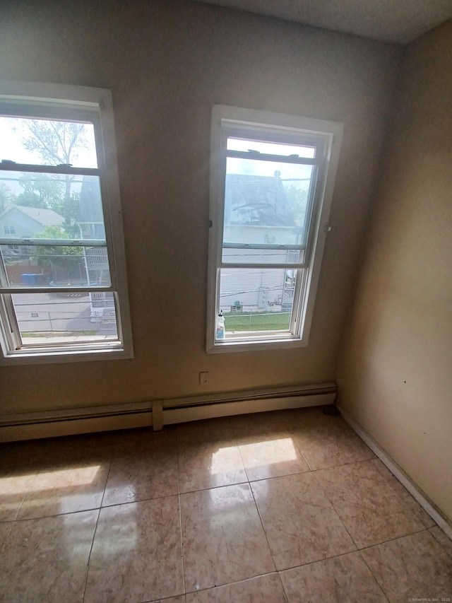 186 Brook St, Hartford, CT 06120 - empty room featuring light tile patterned floors, baseboards, and baseboard heating
