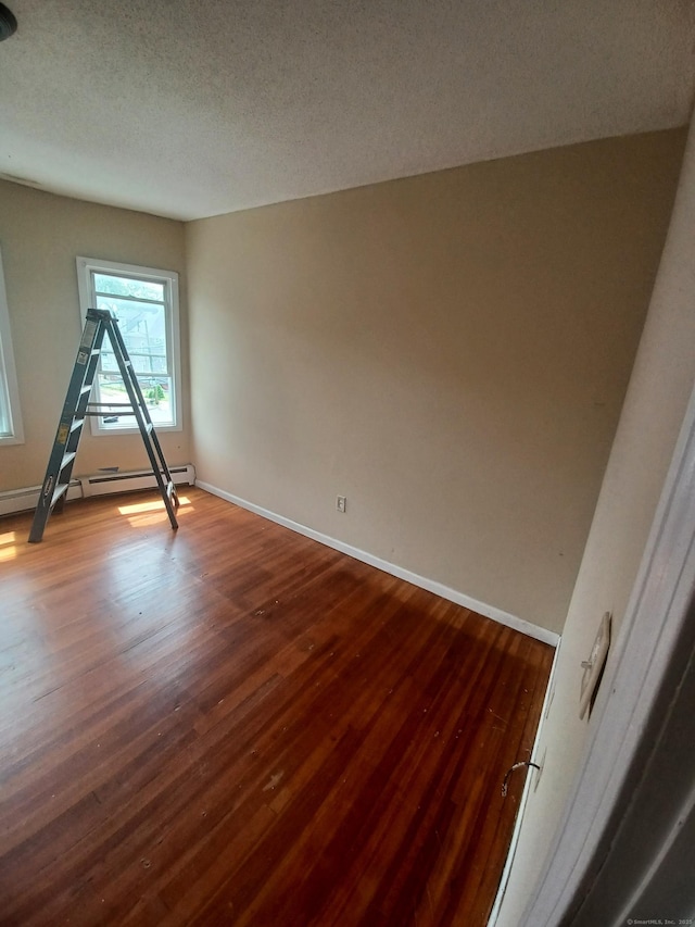 186 Brook St, Hartford, CT 06120 - spare room featuring wood finished floors, baseboards, a baseboard radiator, and a textured ceiling