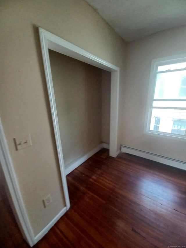 186 Brook St, Hartford, CT 06120 - unfurnished bedroom featuring a baseboard heating unit, wood finished floors, baseboards, and a closet