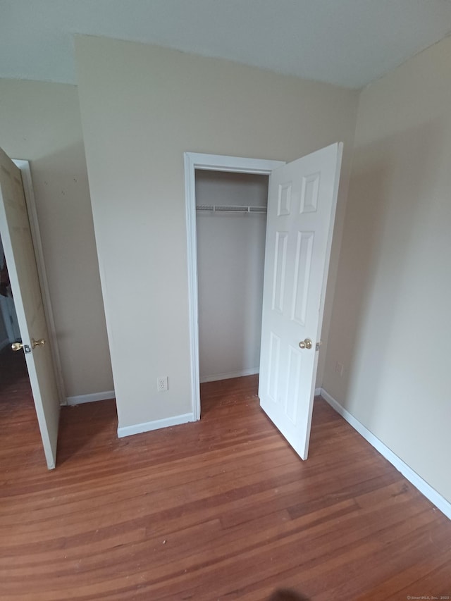 186 Brook St, Hartford, CT 06120 - unfurnished bedroom featuring wood finished floors, a closet, and baseboards