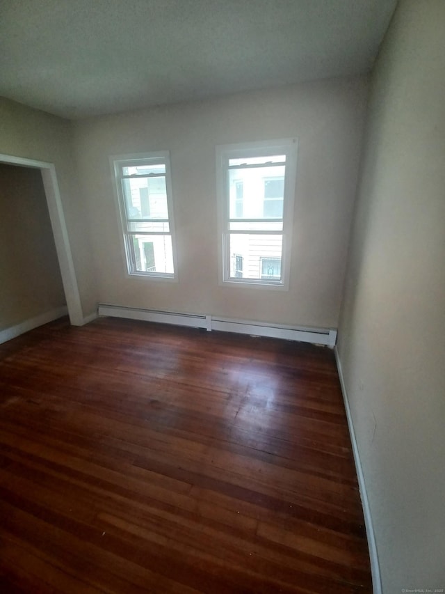 186 Brook St, Hartford, CT 06120 - spare room featuring wood finished floors, a baseboard radiator, and baseboards