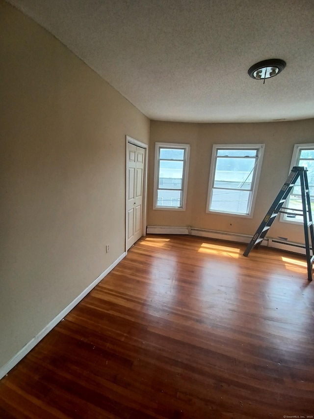 186 Brook St, Hartford, CT 06120 - unfurnished room featuring wood finished floors, baseboards, and a textured ceiling