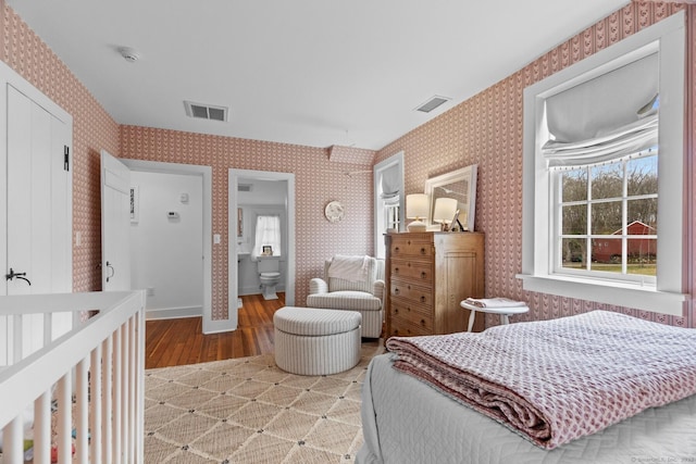 bedroom with light wood-type flooring and wallpapered walls