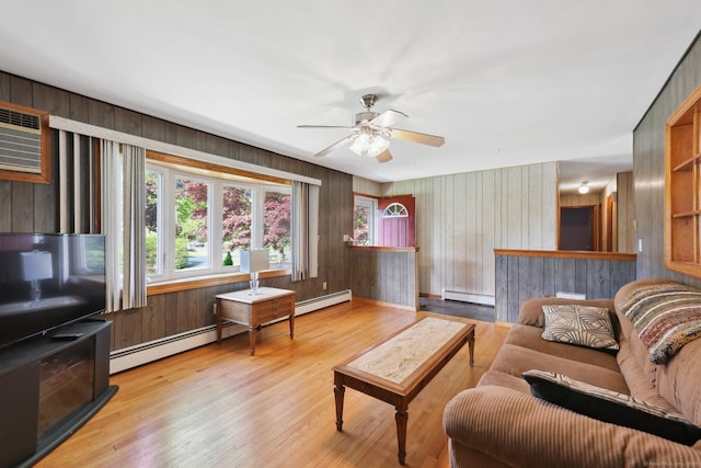 11 Jamestown Rd, Hamden, CT 06518 - living area featuring baseboard heating, ceiling fan, wooden walls, and hardwood / wood-style flooring