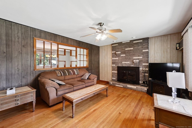 11 Jamestown Rd, Hamden, CT 06518 - living area with a ceiling fan, wood walls, light wood finished floors, and a fireplace