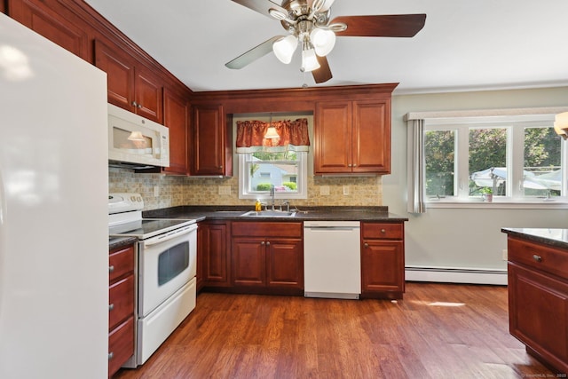 11 Jamestown Rd, Hamden, CT 06518 - kitchen with white appliances, a baseboard radiator, dark countertops, and tasteful backsplash