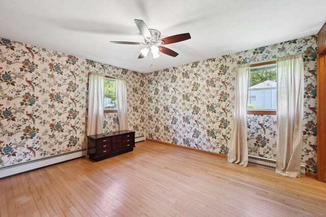 11 Jamestown Rd, Hamden, CT 06518 - spare room with light wood finished floors, a ceiling fan, a baseboard radiator, wallpapered walls, and a baseboard heating unit