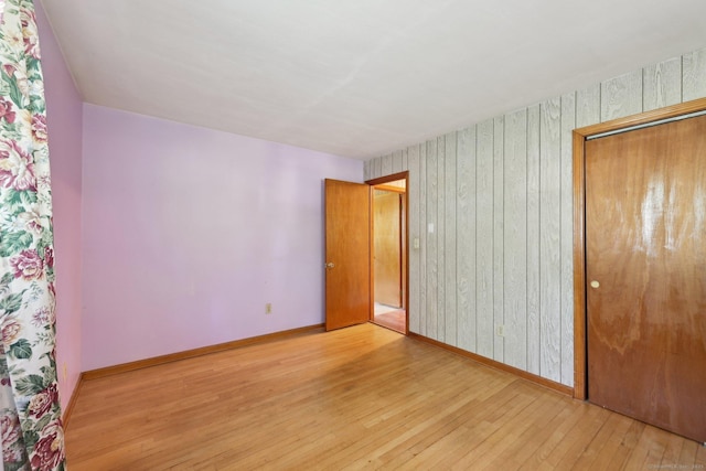 11 Jamestown Rd, Hamden, CT 06518 - unfurnished bedroom with hardwood / wood-style flooring, baseboards, a closet, and wooden walls