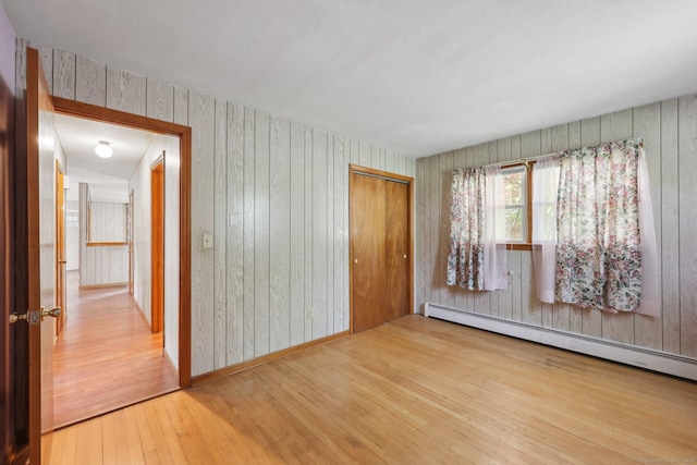 11 Jamestown Rd, Hamden, CT 06518 - spare room featuring a baseboard radiator, hardwood / wood-style flooring, and wood walls