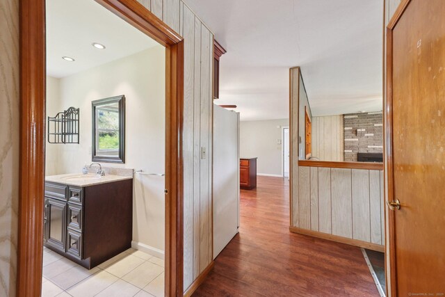 11 Jamestown Rd, Hamden, CT 06518 - corridor featuring a sink, light wood finished floors, and baseboards