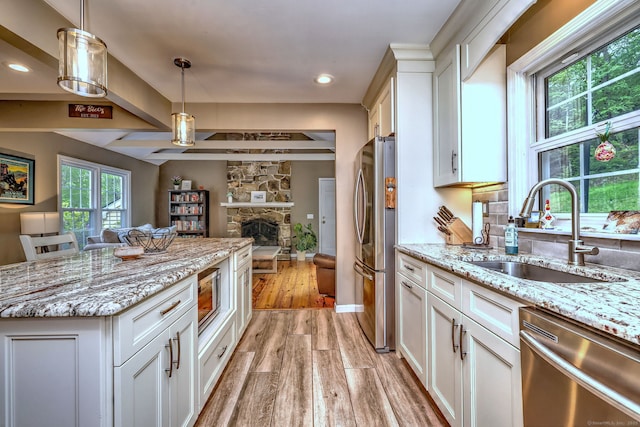 220 Northwood Dr, Guilford, CT 06437 - kitchen with appliances with stainless steel finishes, a sink, open floor plan, light wood-style floors, and white cabinets