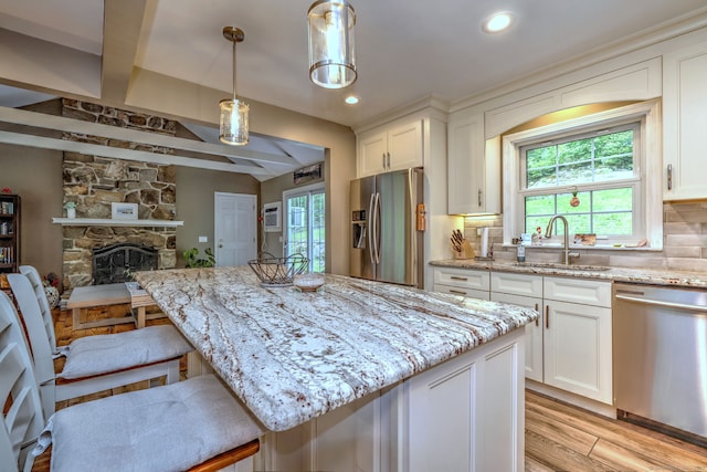 220 Northwood Dr, Guilford, CT 06437 - kitchen with stainless steel appliances, light wood-style floors, healthy amount of natural light, white cabinets, and recessed lighting