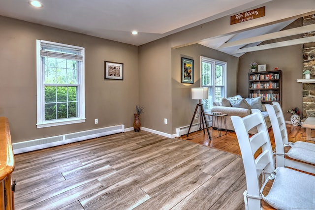 220 Northwood Dr, Guilford, CT 06437 - living area with wood finished floors, a baseboard radiator, baseboard heating, lofted ceiling, and baseboards