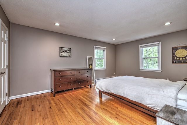 220 Northwood Dr, Guilford, CT 06437 - bedroom with light wood-style floors, baseboards, multiple windows, recessed lighting, and a baseboard radiator