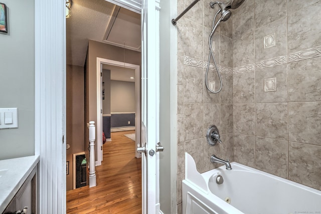 220 Northwood Dr, Guilford, CT 06437 - full bath with wood finished floors, a combined bath / shower with jetted tub, a baseboard radiator, and vanity