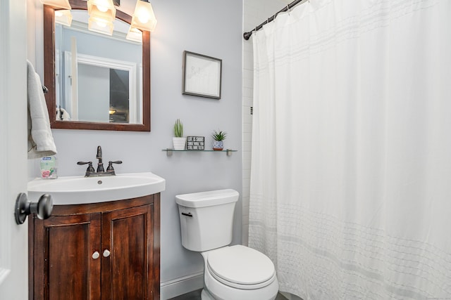 bathroom with toilet, vanity, and a shower with curtain