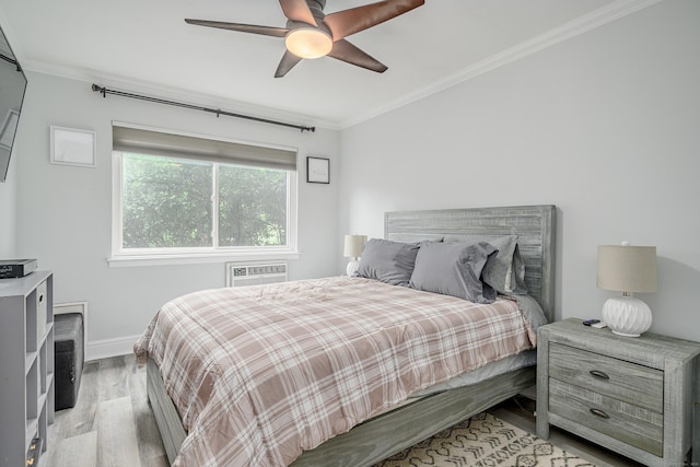 bedroom featuring light wood-type flooring, crown molding, baseboards, and ceiling fan