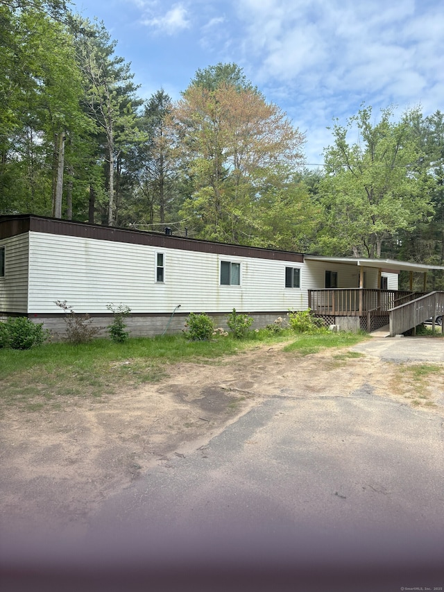 74 Cisar Rd, Willington, CT 06279 - view of front facade featuring a wooden deck and view of wooded area