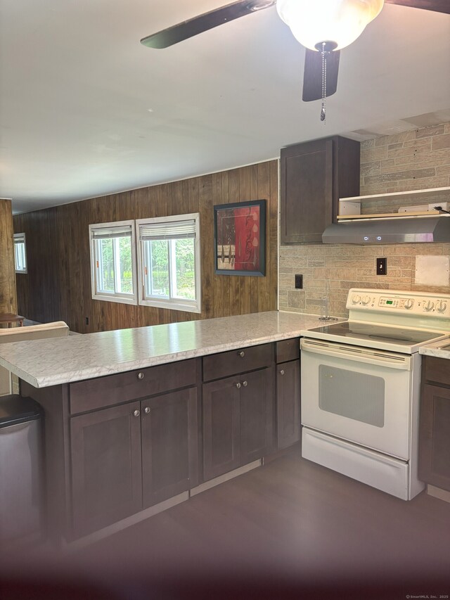 74 Cisar Rd, Willington, CT 06279 - kitchen featuring white range with electric stovetop, a peninsula, wooden walls, dark brown cabinetry, and ceiling fan