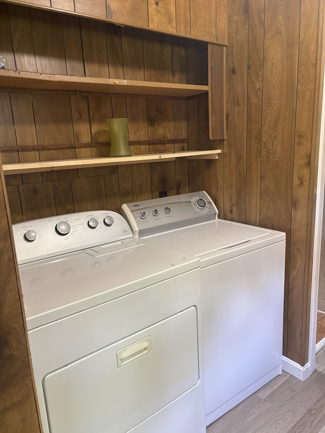 74 Cisar Rd, Willington, CT 06279 - laundry room featuring separate washer and dryer, light wood-type flooring, and wood walls