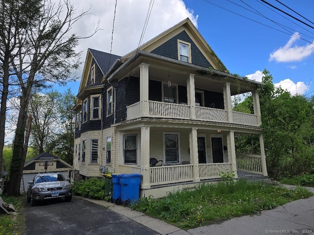 215 Lincoln St, Waterbury, CT 06710 - view of front of home featuring a balcony, covered porch, and a detached garage