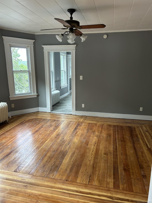 215 Lincoln St, Waterbury, CT 06710 - empty room featuring ceiling fan, radiator, wood finished floors, and baseboards