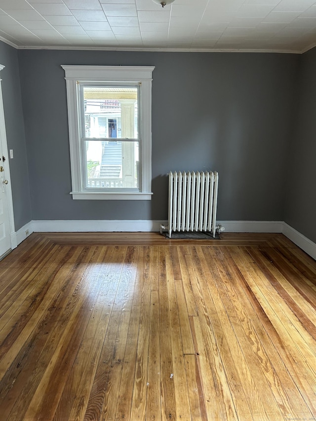 215 Lincoln St, Waterbury, CT 06710 - spare room featuring radiator, ornamental molding, hardwood / wood-style floors, and baseboards
