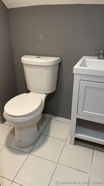 215 Lincoln St, Waterbury, CT 06710 - bathroom with tile patterned flooring, toilet, and vanity