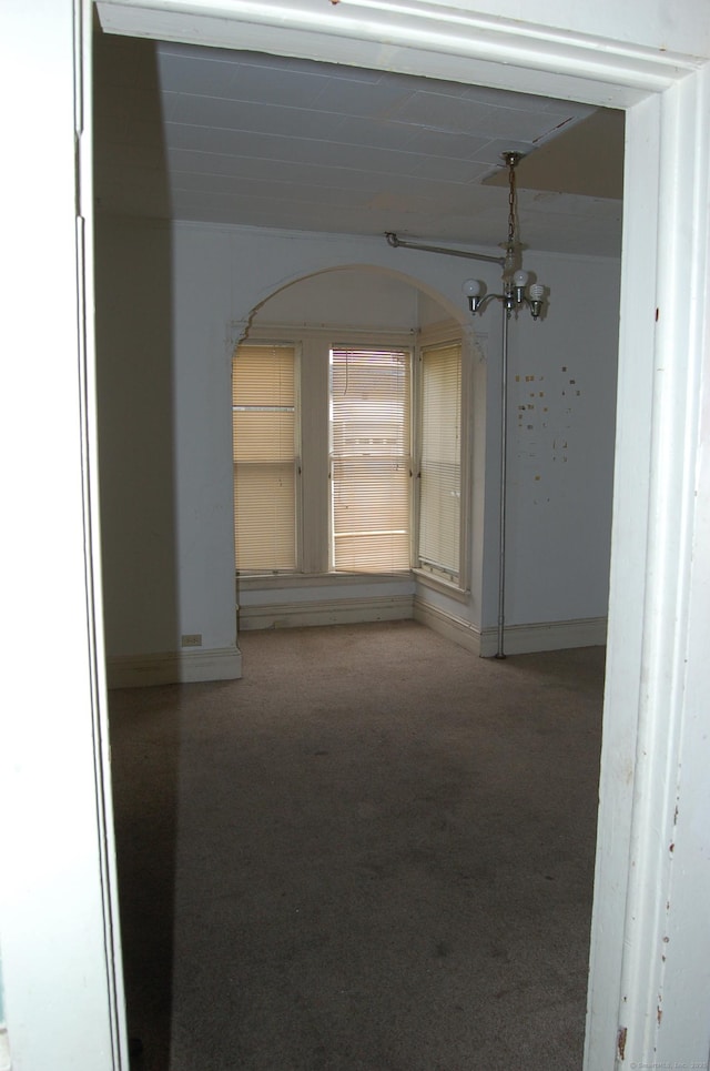 26 Jefferson Ave, New London, CT 06320 - hall with carpet, arched walkways, a chandelier, and baseboards