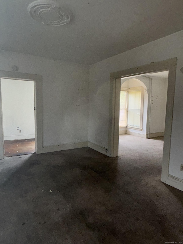 26 Jefferson Ave, New London, CT 06320 - empty room featuring arched walkways and baseboards