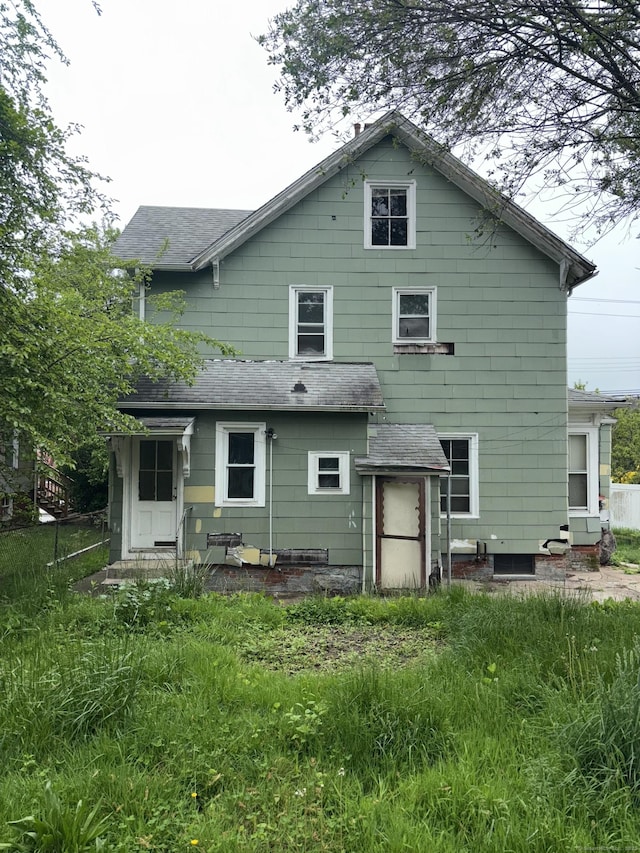 26 Jefferson Ave, New London, CT 06320 - rear view of house with a shingled roof and fence